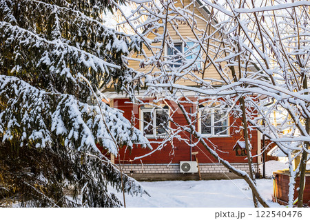 vew of small wooden cottage from snowy backyard vew of small wooden cottage from snowy backyard 122540476
