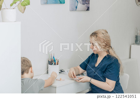 speech therapist engaging with boy in nonverbal communication training, concept of education and cognitive skills development 122541051