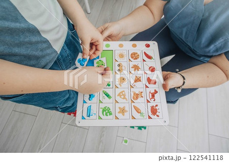 child engaging in color-matching on educational board in structured learning environment, concept of cognitive development, early childhood education, therapy child engaging in color-matching on educational board in structured learning environment, concept of cognitive development, early childhood education, therapy 122541118