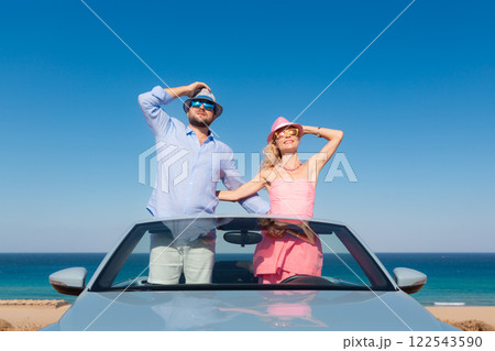 Happy couple in love travel by car by the sea Happy couple in love travel by car by the sea 122543590