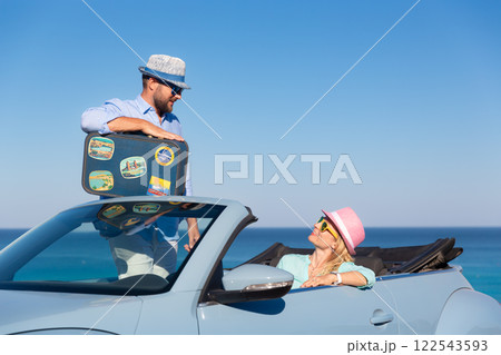 Happy couple in love travel by car by the sea Happy couple in love travel by car by the sea 122543593