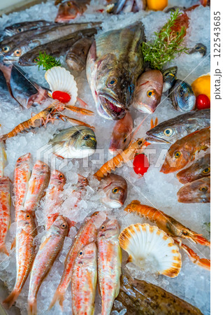 Different fresh sea food for a choice on ice in market or restaurant in small town of Montenegro. Seafood of adriatic sea 122543685