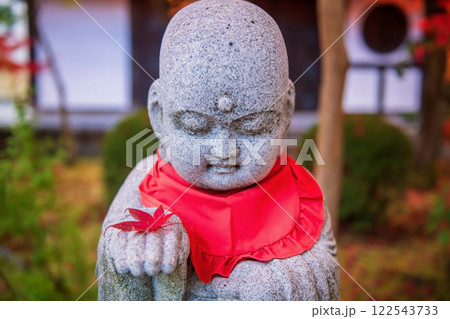 Jizo statue with maple leaf on hand at fall garden Eikando Temple, Kyoto 122543733