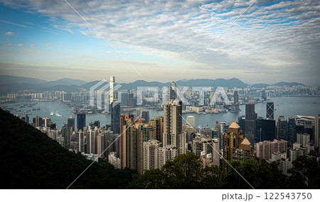Aerial view of Hong Kong with many buildings and mountains behind 122543750