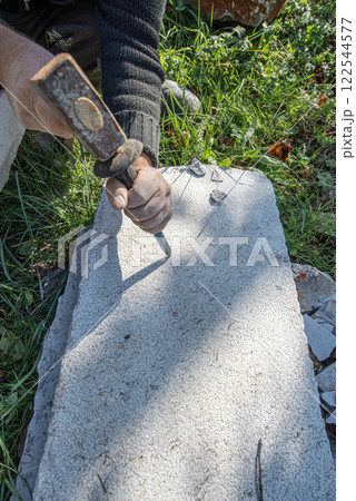 Artist carving in stone 122544577