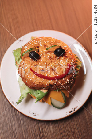 juicy children's burger with a painted face made juicy children's burger with a painted face made 122544684