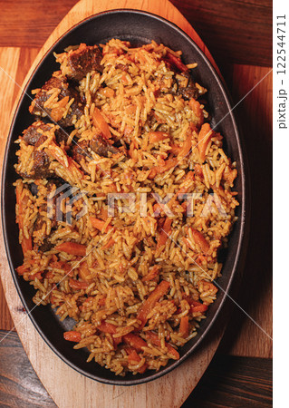 Pilaf in beautiful dishes is on the table in the 122544711