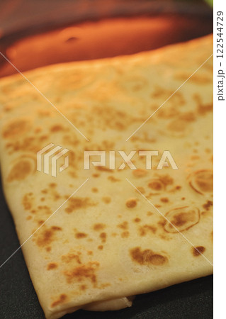 thin pancakes with ham and cheese in an envelope 122544729