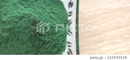Close up photo of powdered spirulina, selective focus. 122545519