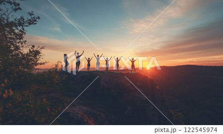 Silhouetted figures celebrating at sunset. 122545974
