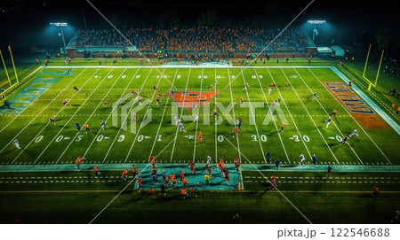 Night football game aerial view, players on field, crowd in stadium. Night football game aerial view, players on field, crowd in stadium. 122546688