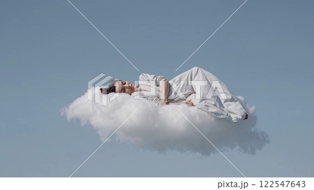 Woman sleeping peacefully on a cloud in the sky 122547643