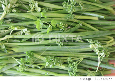 fresh herbs prepared for salads. Parsley and green onions. Proper nutrition, vitamins. 122548077