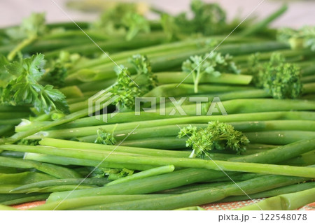 fresh herbs prepared for salads. Parsley and green onions. Proper nutrition, vitamins. 122548078
