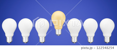 Light bulbs in a line, with one shining uniquely, representing an idea and career concept of standing out. 122548254