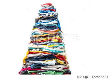 A very tall stack of folded colored clothes for charity, washing, ironing and sorting. 122548423