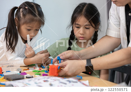 Education STEM children student classroom in school. Robot assembly training, brain development, Kid learning electrical future engineering. Education STEM children student classroom in school. Robot assembly training, brain development, Kid learning electrical future engineering. 122550571