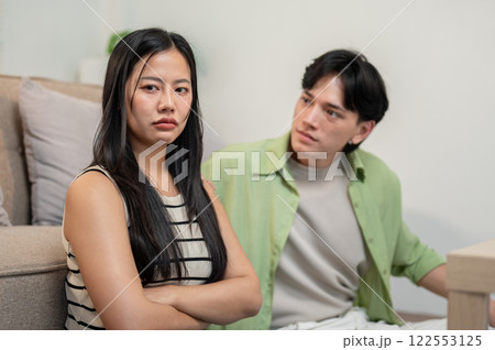 A moody and upset Asian girl has a conflict with her boyfriend, ignoring him while he explains. 122553125