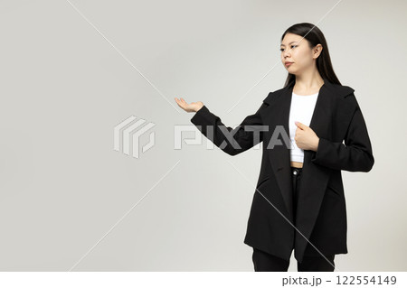 A girl of Asian appearance in a strict, classic suit. A girl of Asian appearance in a strict, classic suit. 122554149