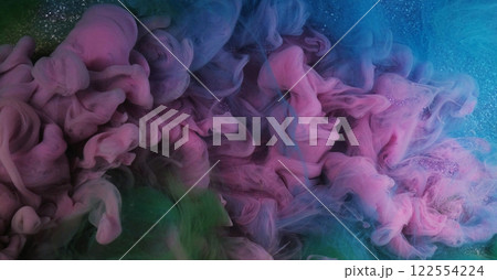 Color water flow. Ink smoke. Defocused pink green blue glowing splashes paint texture haze floating on purple shimmering abstract art light background. 122554224