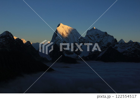 Bright lit Cholatse, view from Gokyo Ri, Nepal. Bright lit Cholatse, view from Gokyo Ri, Nepal. 122554517