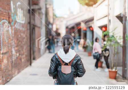 woman traveler visiting in Taiwan, Tourist with backpack sightseeing at Bopiliao Historic Block, landmark and popular attractions in Taipei city. Asia Travel and vacation concept woman traveler visiting in Taiwan, Tourist with backpack sightseeing at Bopiliao Historic Block, landmark and popular attractions in Taipei city. Asia Travel and vacation concept 122555129