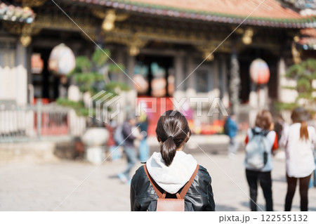 woman traveler visiting in Taiwan, female Tourist sightseeing at Longshan Temple, Chinese folk religious temple in Wanhua District, Taipei City. landmark and popular. Travel and Vacation concept woman traveler visiting in Taiwan, female Tourist sightseeing at Longshan Temple, Chinese folk religious temple in Wanhua District, Taipei City. landmark and popular. Travel and Vacation concept 122555132