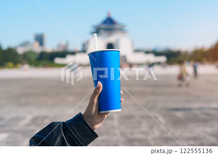 woman hand holding Pearl bubble milk tea glasses. traveler at National Chiang Kai shek Memorial, a famous beverages in Taipei, Taiwan woman hand holding Pearl bubble milk tea glasses. traveler at National Chiang Kai shek Memorial, a famous beverages in Taipei, Taiwan 122555136