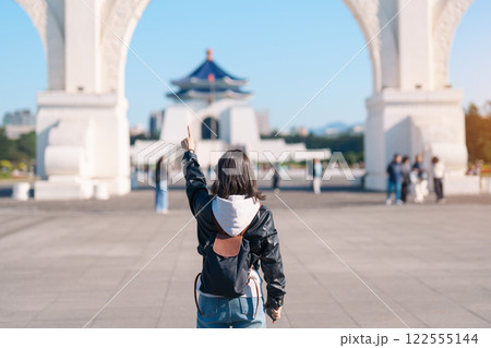 woman traveler visiting in Taiwan, female Tourist sightseeing at National Chiang Kai shek Memorial or Hall Freedom Square, Taipei City. Popular landmark and attractions. Asia Travel concept 122555144