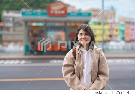 woman traveler visiting in Taiwan, female Tourist with backpack sightseeing at Keelung, Colorful Zhengbin Fishing Port. Popular landmarks and attractions near Taipei City.  Asia Travel concept 122555146