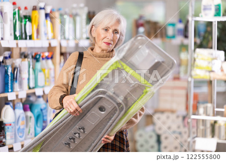 Woman choosing an ironing board 122555800