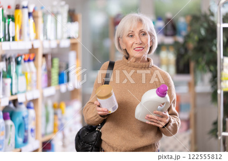 Mature woman choosing laundry detergent in department store 122555812
