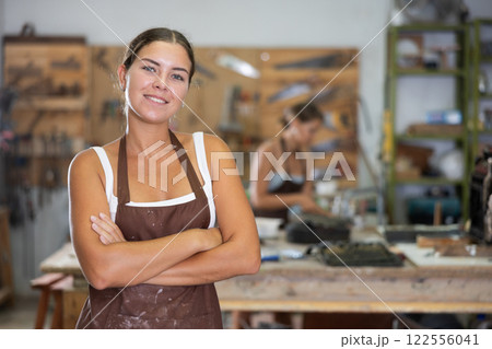 Young girl posing in taller workshop Young girl posing in taller workshop 122556041