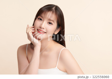 Beautiful young asian woman with clean fresh skin on beige background, Face care, Facial treatment, Cosmetology, beauty and spa, Asian women portrait. Beautiful young asian woman with clean fresh skin on beige background, Face care, Facial treatment, Cosmetology, beauty and spa, Asian women portrait. 122556060