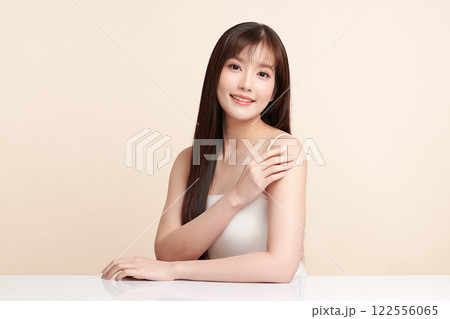 Beautiful young asian woman with clean fresh skin on beige background, Face care, Facial treatment, Cosmetology, beauty and spa, Asian women portrait. Beautiful young asian woman with clean fresh skin on beige background, Face care, Facial treatment, Cosmetology, beauty and spa, Asian women portrait. 122556065
