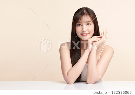 Beautiful young asian woman with clean fresh skin on beige background, Face care, Facial treatment, Cosmetology, beauty and spa, Asian women portrait. 122556069