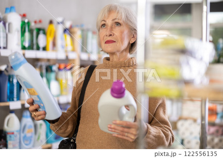 Mature woman choosing laundry detergent in department store 122556135