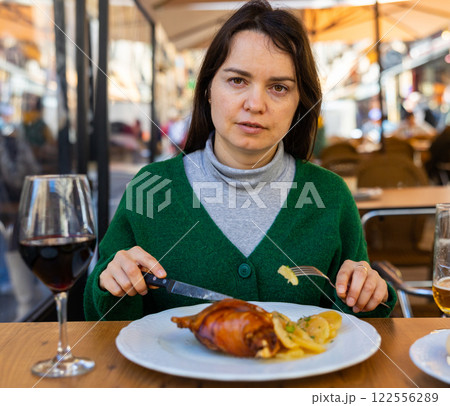 Woman traveler eating fried toston in restaurant of Salamanca 122556289