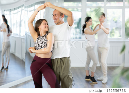 Young couple enjoying impassioned merengue in latin dance class 122556738