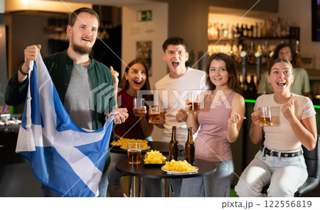 Group of fans in bar with Scottish flag Group of fans in bar with Scottish flag 122556819