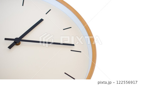 A minimalist wooden-framed clock with clean black hands and markers, set against a simple white background. A minimalist wooden-framed clock with clean black hands and markers, set against a simple white background. 122556917