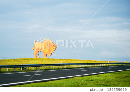 Belarus, August 2023: The symbol of Belovezhskaya Pushcha is a monument to a bison by the road Belarus, August 2023: The symbol of Belovezhskaya Pushcha is a monument to a bison by the road 122559636