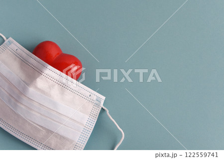Red heart and medical mask on a blue background. Health and medicine concept. 122559741