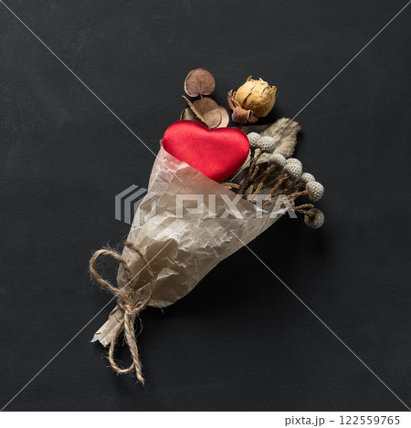 Valentine's Day - a bag with a heart as a gift on a black background 122559765