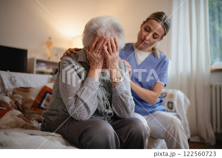 Psychologist provides mental health support and grief counseling to elderly patient. Psychologist provides mental health support and grief counseling to elderly patient. 122560723