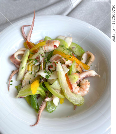 Mix of seafood and vegetables on plate. Asian cuisine. Healthy food and longevity. Mix of seafood and vegetables on plate. Asian cuisine. Healthy food and longevity. 122560750