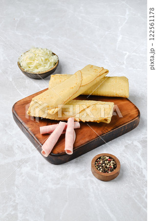 Delicious traditional tortillas served with pickled vegetables on a wooden board 122561178