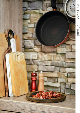 Cooking preparation with wooden cutting boards and ingredients in a rustic kitchen Cooking preparation with wooden cutting boards and ingredients in a rustic kitchen 122561208