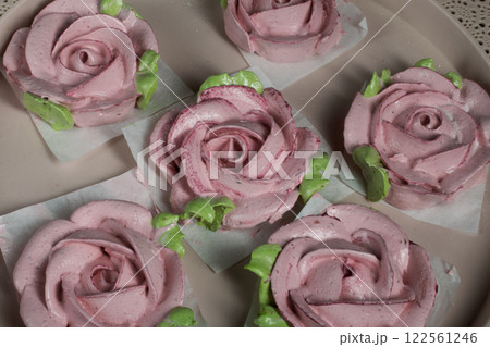 Roses from marshmallows. Zephyr flowers. Sprinkled with powdered sugar. Roses from marshmallows. Zephyr flowers. Sprinkled with powdered sugar. 122561246