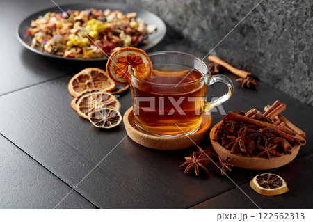 Cup of herbal tea with ingredients and slices of dried orange slices. Cup of herbal tea with ingredients and slices of dried orange slices. 122562313